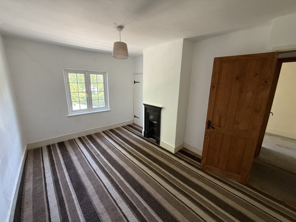 Lot: 168 - DETACHED COTTAGE IN ESSEX VILLAGE LOCATION - Bedroom 2 with fireplace and window